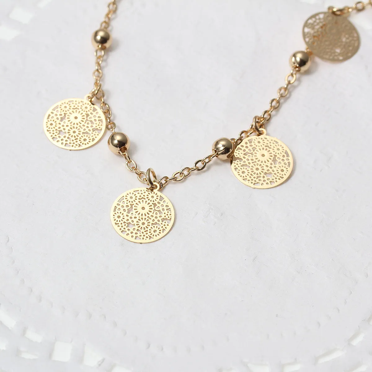 SEXY SPARKLES Filigree Stamping Bell Bracelet Gold Plated Whit Round Hollow Pendants